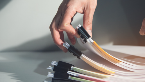 Stock Image of a hand picking up Multiple files