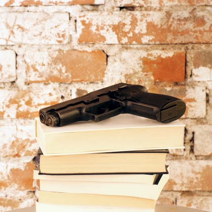 Gun on top of stack of Books