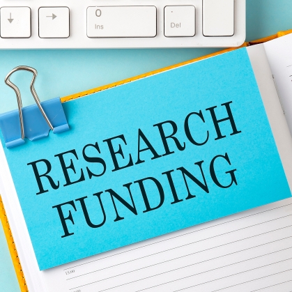 Stock Photo of the words "research funding" on a clipboard